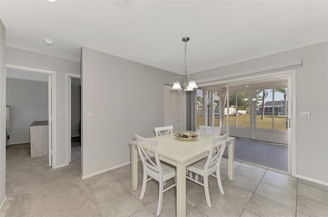 dining space with a chandelier and light tile patterned floors