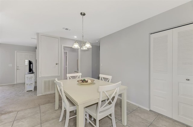 dining room with a notable chandelier and light tile patterned floors