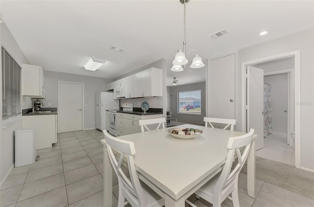 dining area with light tile patterned floors, ceiling fan, and sink