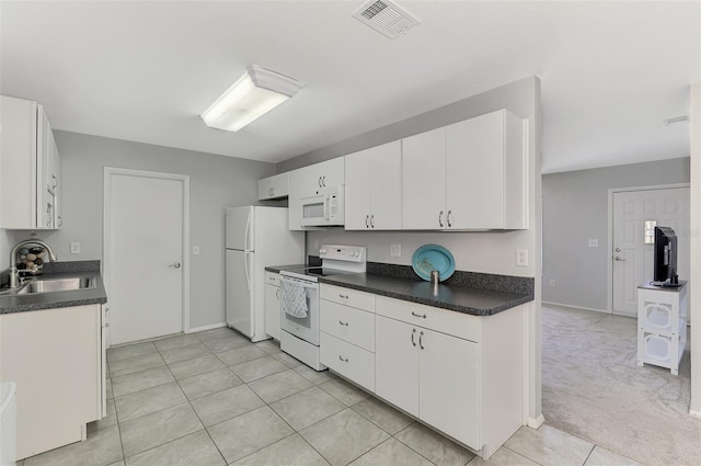 kitchen with white cabinetry, sink, light colored carpet, and white appliances