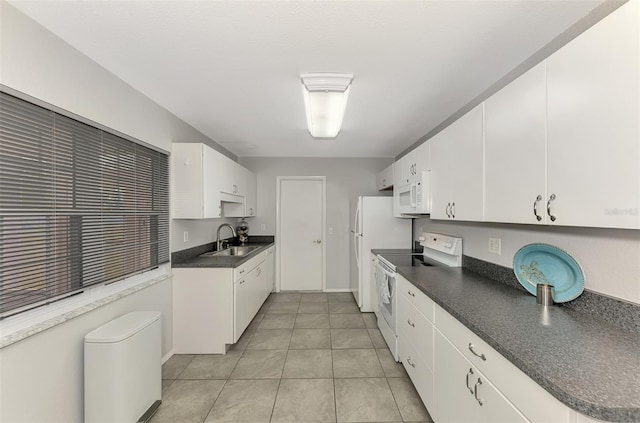 kitchen featuring sink, white cabinets, light tile patterned flooring, and white appliances