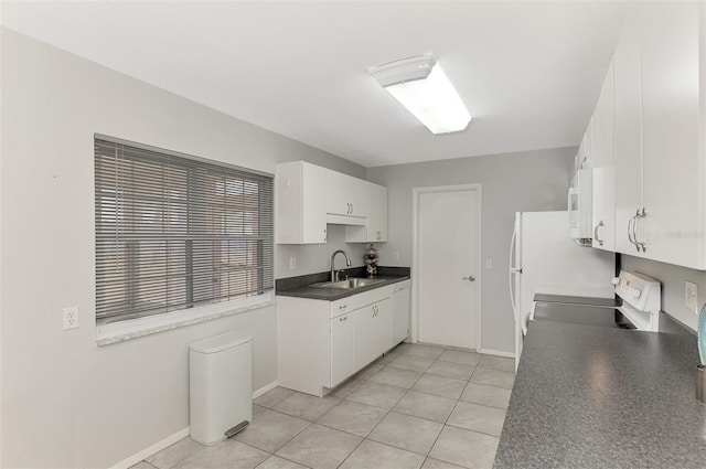 kitchen featuring white cabinets, light tile patterned floors, white appliances, and sink