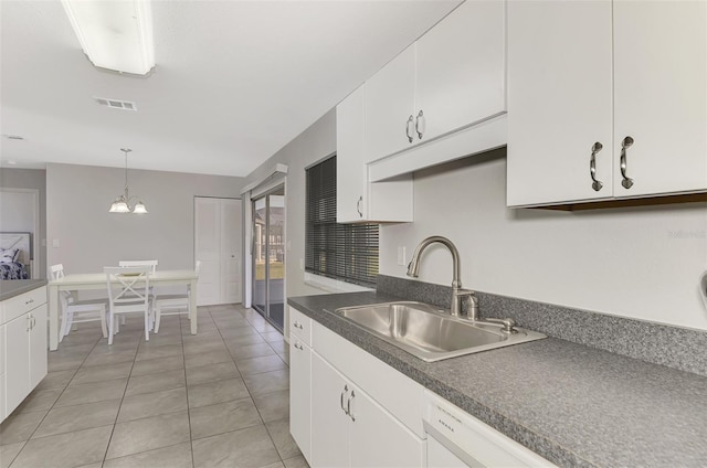 kitchen with decorative light fixtures, white cabinetry, white dishwasher, and sink