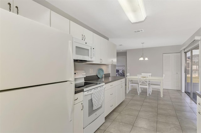 kitchen featuring white appliances, light tile patterned floors, decorative light fixtures, a chandelier, and white cabinetry