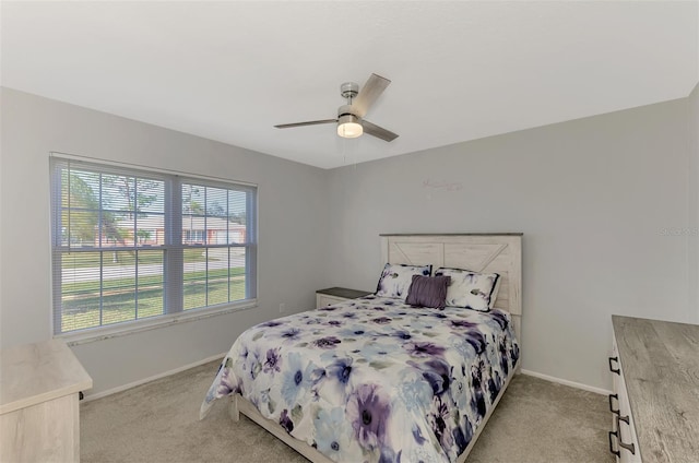 bedroom featuring ceiling fan and light colored carpet