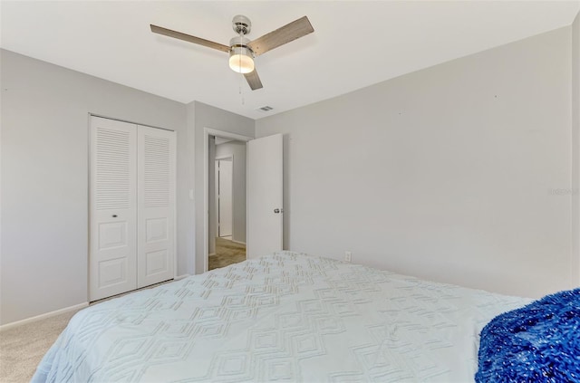 bedroom with light carpet, a closet, and ceiling fan