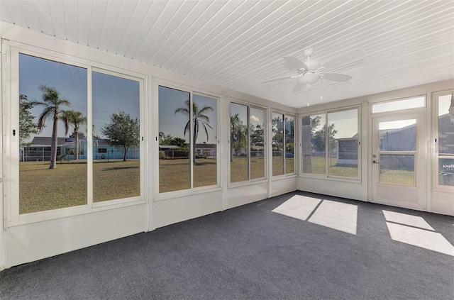 unfurnished sunroom featuring ceiling fan