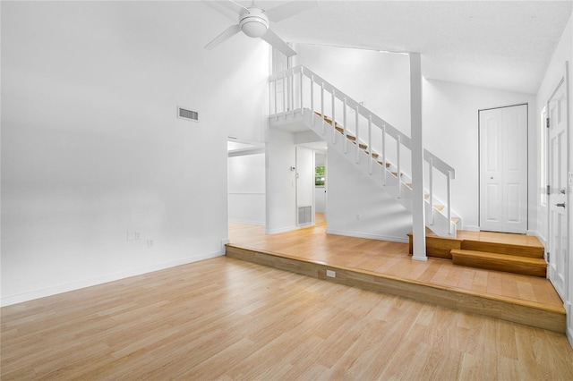 interior space with hardwood / wood-style floors, high vaulted ceiling, and ceiling fan