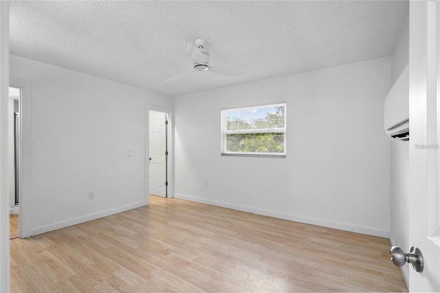 unfurnished room with ceiling fan, light hardwood / wood-style floors, and a textured ceiling