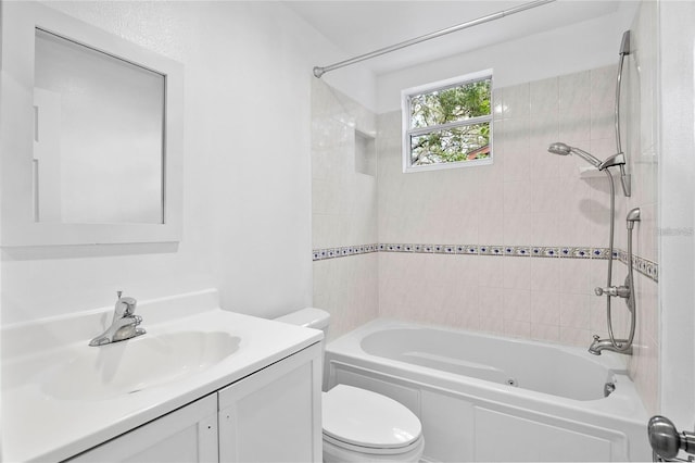 full bathroom featuring vanity, toilet, and tiled shower / bath