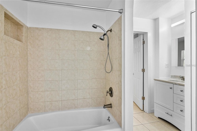 bathroom with tile patterned floors, tiled shower / bath combo, and vanity