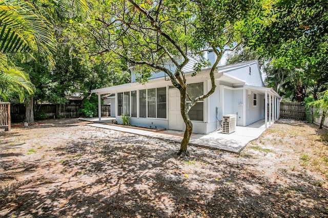 rear view of house featuring a sunroom
