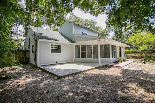 rear view of property with a patio area and a sunroom
