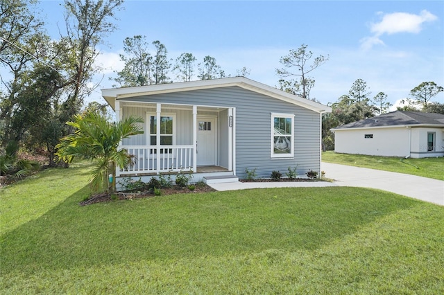 view of front facade with a front lawn and a porch