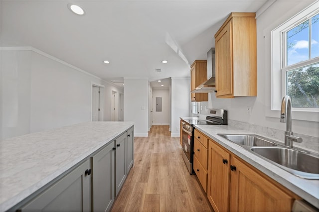 kitchen with light wood-type flooring, wall chimney exhaust hood, crown molding, sink, and stainless steel range with electric cooktop