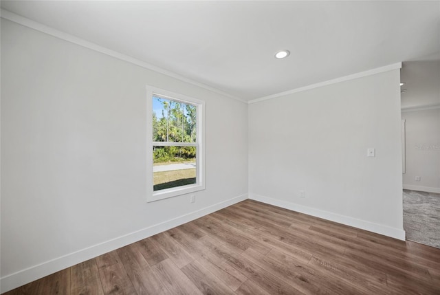 spare room with hardwood / wood-style floors and ornamental molding