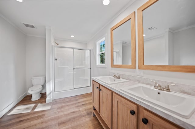 bathroom featuring wood-type flooring, toilet, an enclosed shower, and ornamental molding