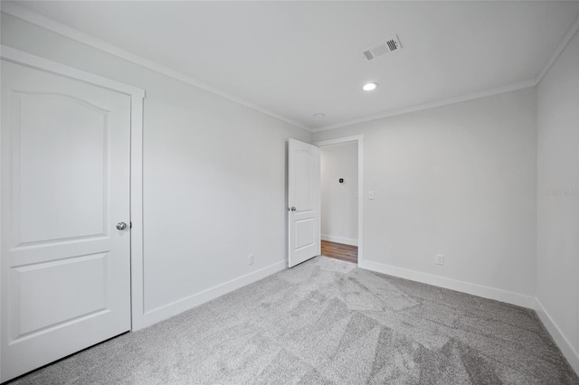 carpeted empty room with crown molding