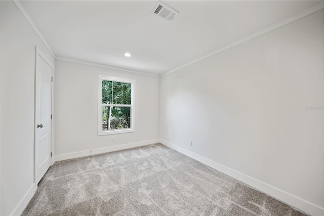 empty room with light colored carpet and ornamental molding