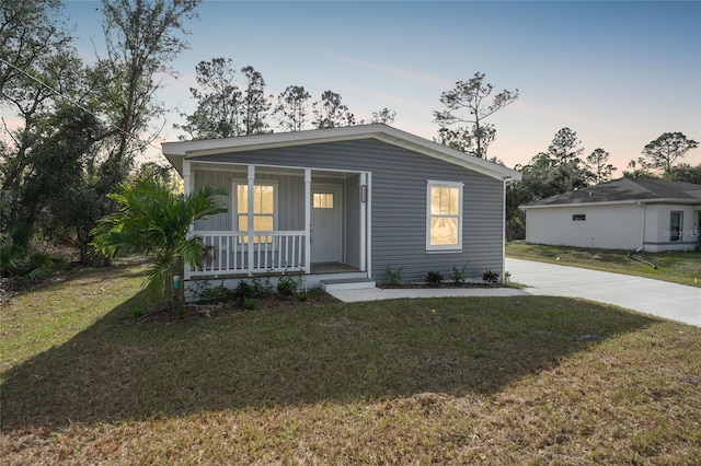 view of front of home featuring a yard and covered porch