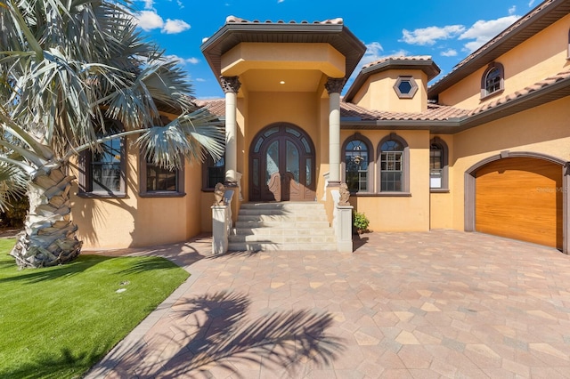 mediterranean / spanish-style house with french doors and a garage