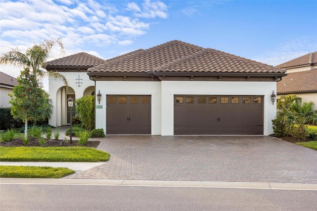 mediterranean / spanish house with a garage