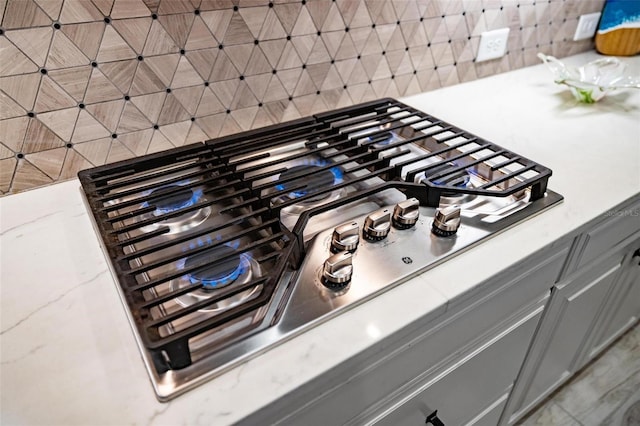 details featuring stainless steel gas stovetop and gray cabinets