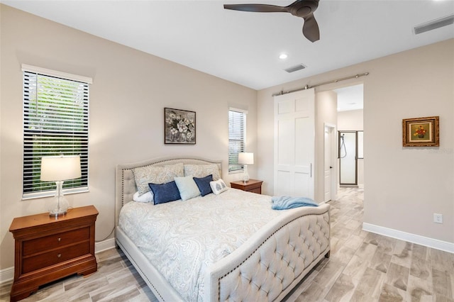 bedroom featuring multiple windows, ceiling fan, a closet, and light hardwood / wood-style floors