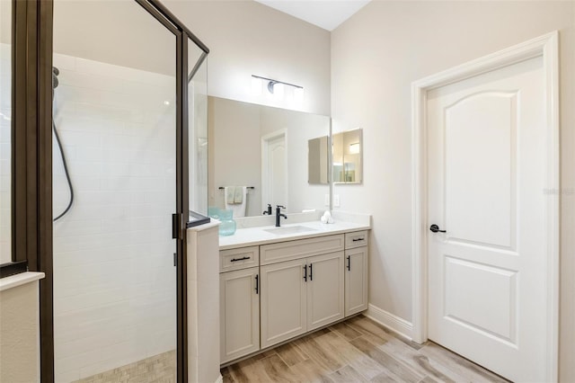 bathroom with vanity and a shower with door