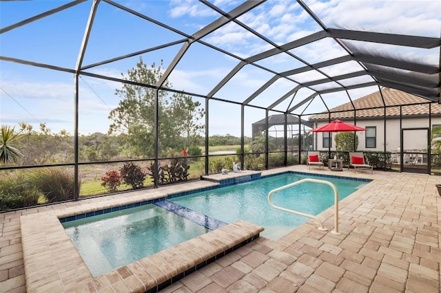 view of swimming pool featuring a lanai and a patio