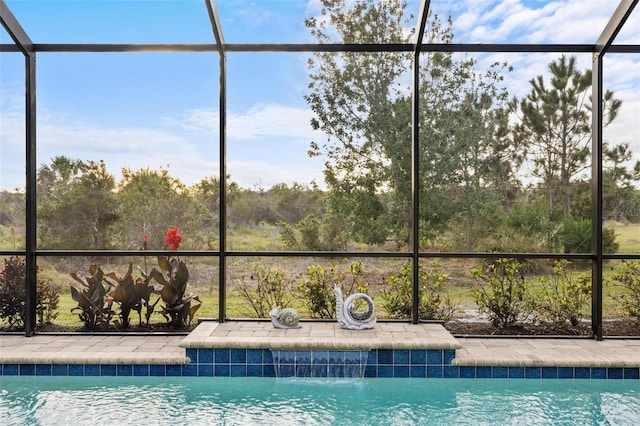 view of pool with glass enclosure