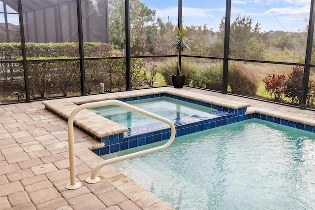 view of swimming pool with glass enclosure and an in ground hot tub