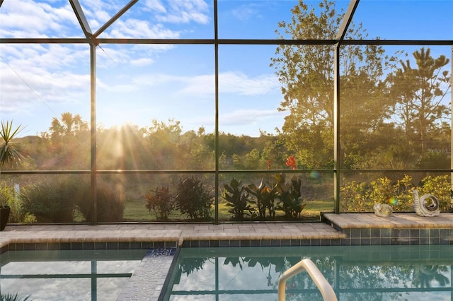 view of swimming pool featuring glass enclosure