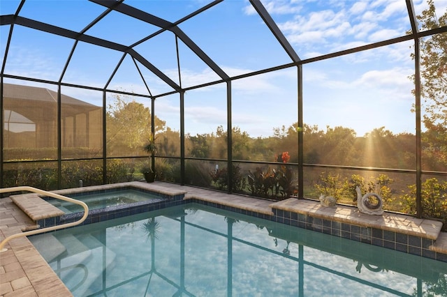 view of swimming pool featuring glass enclosure and an in ground hot tub