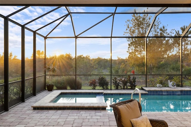 view of swimming pool with a patio area, a lanai, and an in ground hot tub