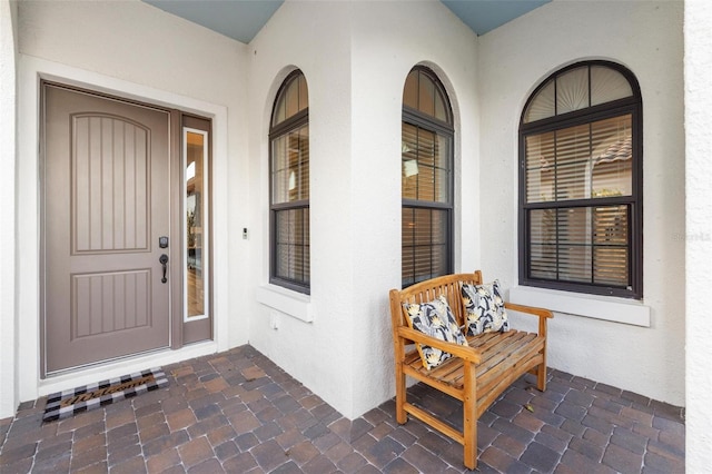 view of exterior entry with covered porch