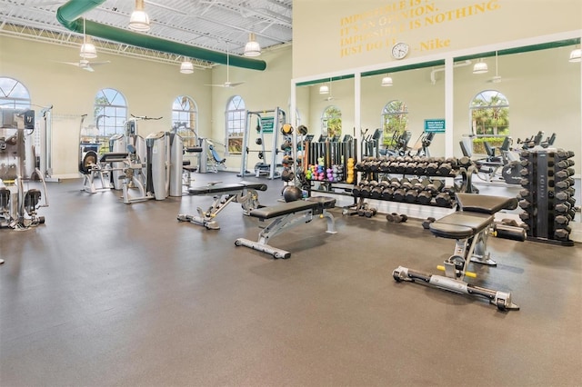 gym featuring a high ceiling and ceiling fan