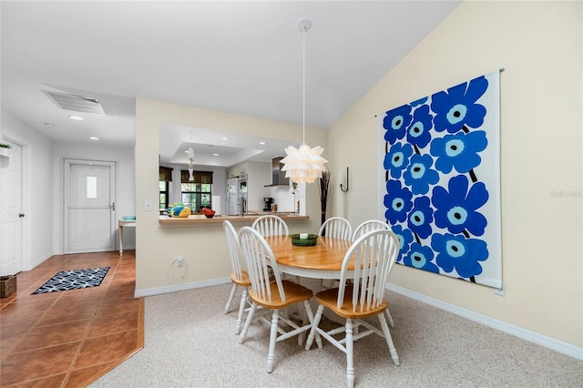 dining space featuring tile patterned flooring and a notable chandelier