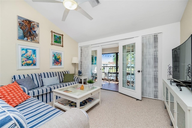 carpeted living room with french doors, ceiling fan, and lofted ceiling