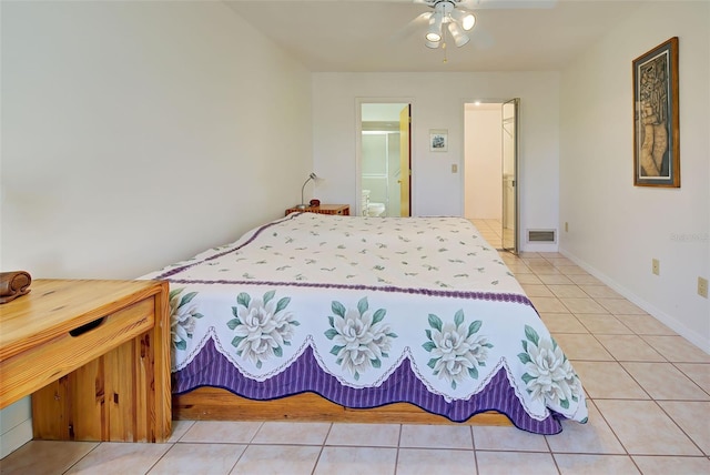 bedroom with tile patterned floors, connected bathroom, and ceiling fan