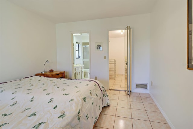 tiled bedroom featuring ensuite bath