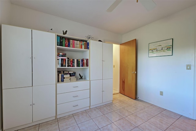 unfurnished bedroom featuring a closet, ceiling fan, and light tile patterned flooring