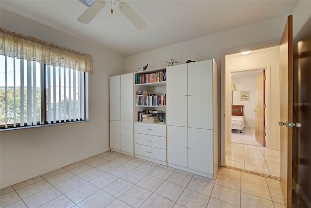 unfurnished bedroom featuring light tile patterned floors and ceiling fan