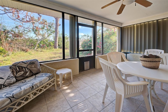 sunroom / solarium featuring ceiling fan