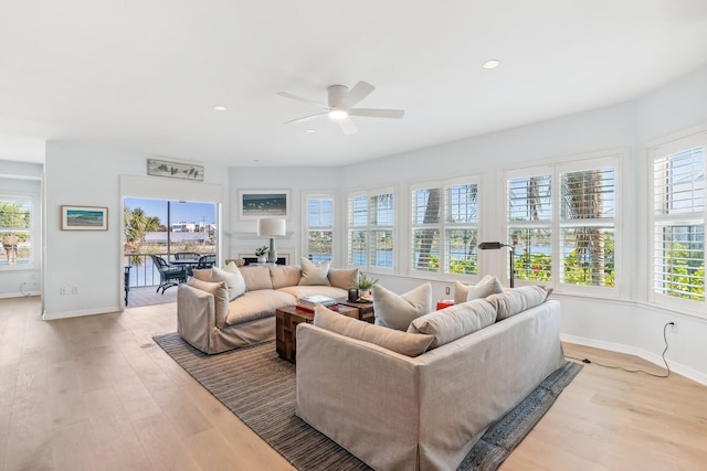 living room with recessed lighting, light wood-style floors, baseboards, and ceiling fan