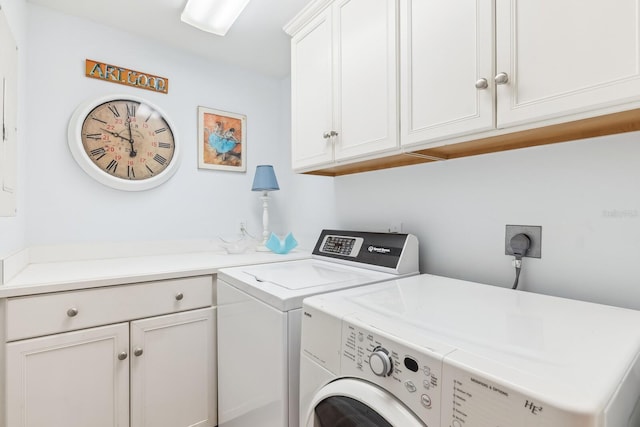 clothes washing area with cabinet space and separate washer and dryer