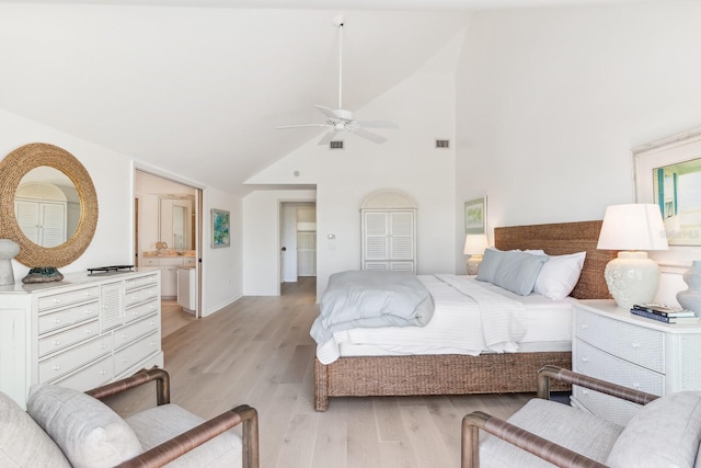 bedroom featuring a ceiling fan, visible vents, light wood-type flooring, and high vaulted ceiling