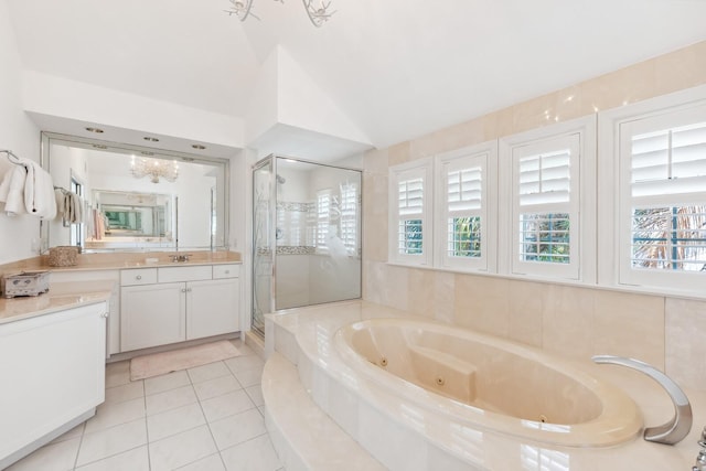 bathroom with tile patterned floors, a stall shower, plenty of natural light, a jetted tub, and vaulted ceiling