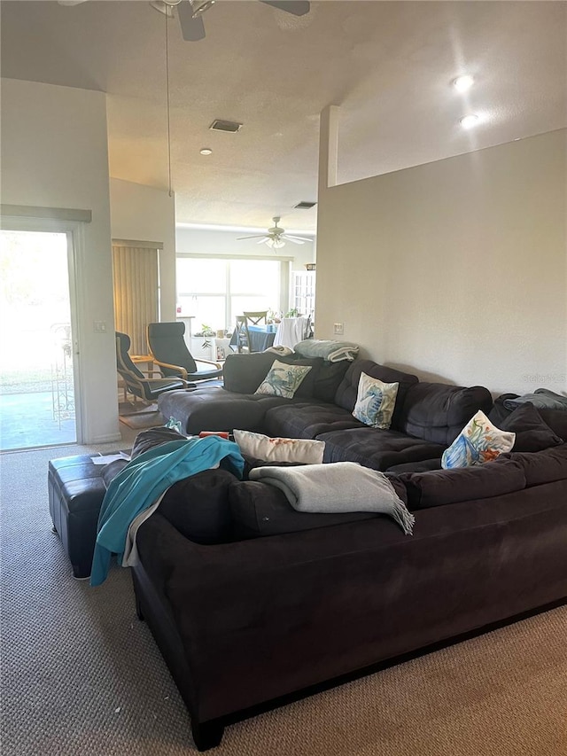 carpeted living room with ceiling fan