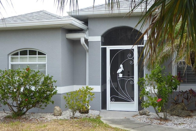 328 Baytree Dr, Rotonda West, FL 33947 - doorway to property featuring stucco siding